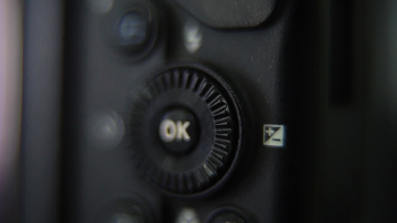 Macro shot of a DSLR camera, menu buttons close up, studio lighting, photography gear, slow motion 120 fps, Full HD video, push in movement