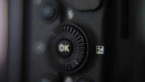 macro shot of a dslr camera, menu buttons close up, studio lighting, photography gear, slow motion 120 fps, full hd video, push in movement