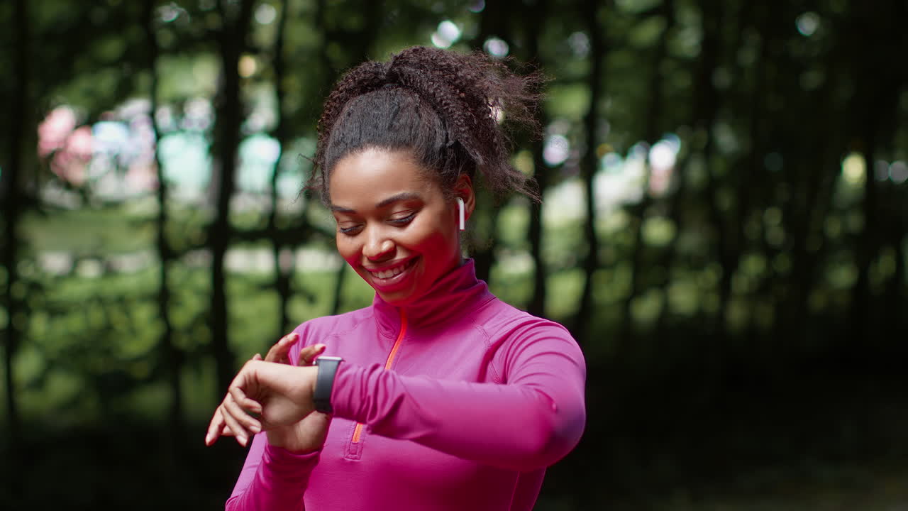 Woman Checking Fitness Tracker in a Park