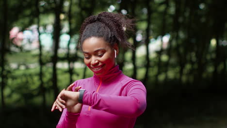 woman checking fitness tracker in a park