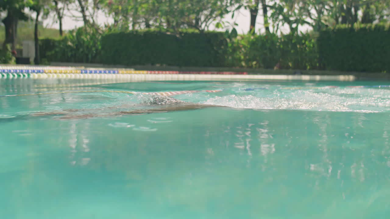 Black Swimmer Training in Pool Outdoors