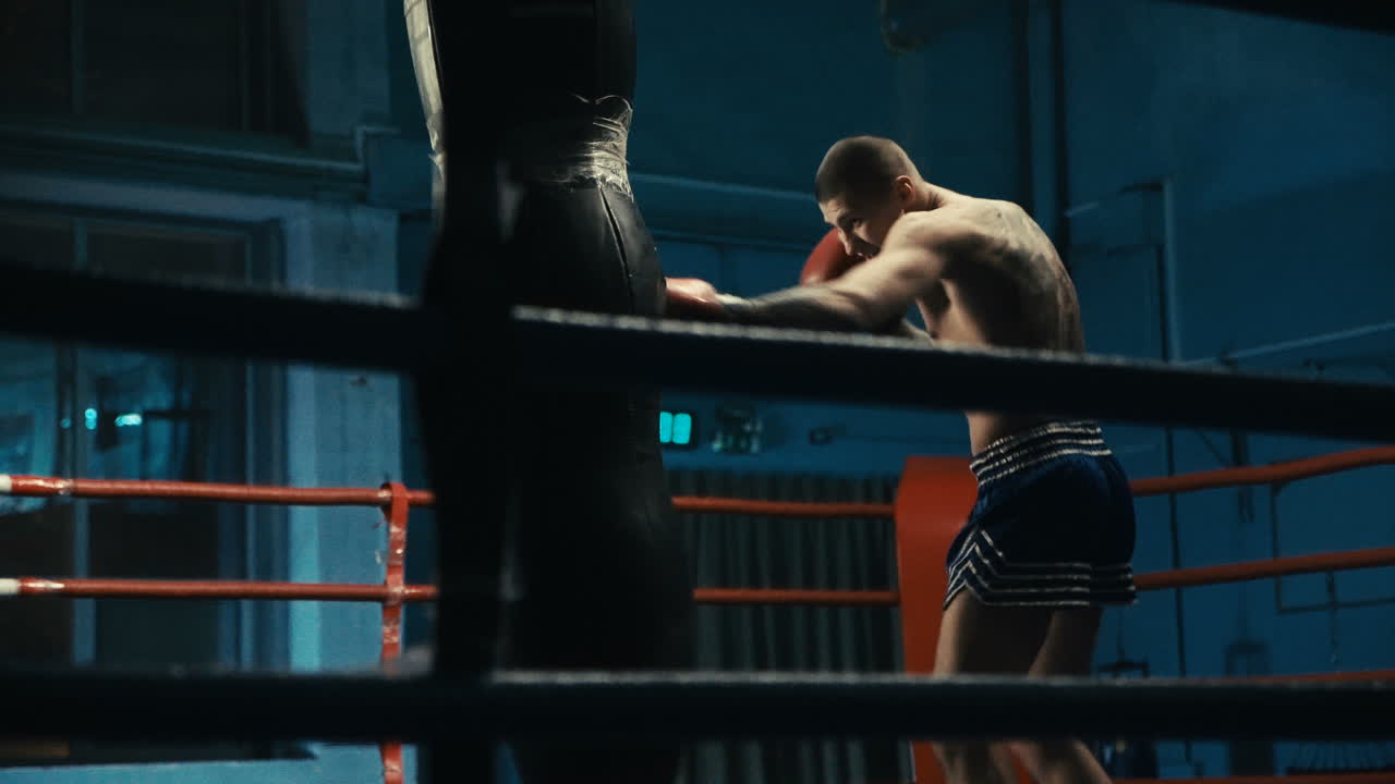 Man training Muay Thai in boxing ring