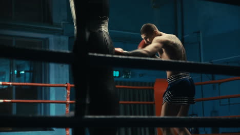 man training muay thai in boxing ring