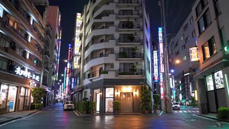 wet asphalt reflecting neon signs illuminating a tokyo street at night, with a white building and a small shop, creating a serene and captivating urban nightscape