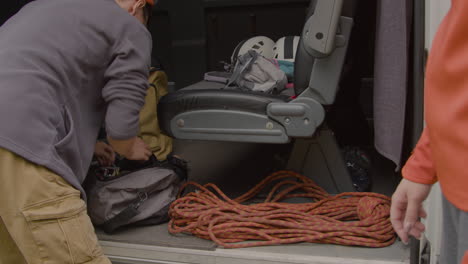 couple gathering the equipment for climbing