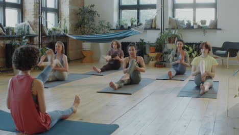 group of women doing warmup before yoga practice