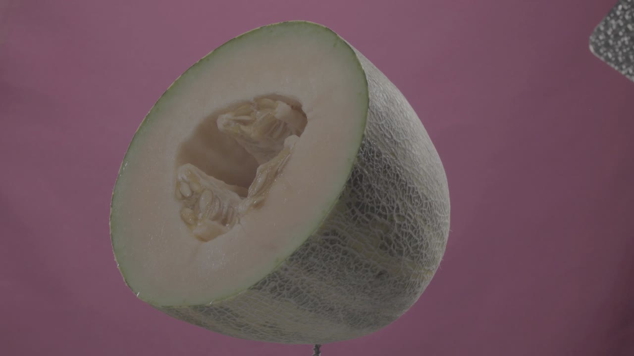 Melon rotating with loop on fuchsia screen for chroma key