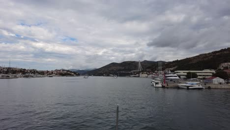 The-serene-view-from-a-slowly-floating-boat-over-the-bay-area-of-Cavtat,-Croatia,-captures-the-essence-of-tranquility-and-coastal-beauty