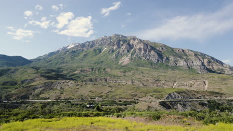 a drone pulls back in a parallax view of mount timpanogos in utah usa