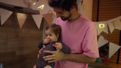 father and baby celebrating birthday