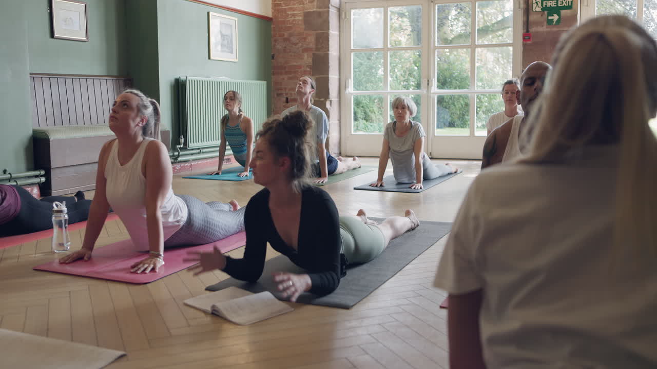 Yoga class in cobra pose