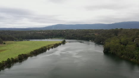 aerial drone shot flying up the shoalhaven river on a stormy day near nowra, nsw australia