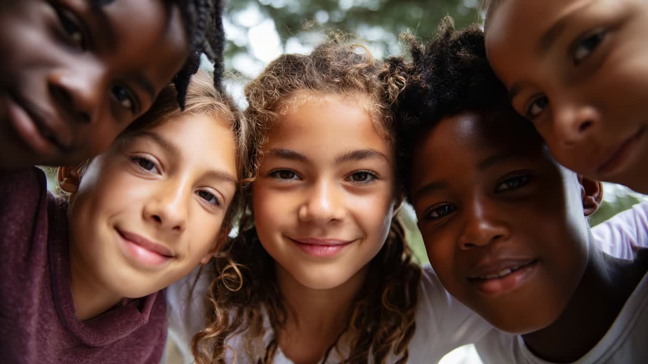 A Joyful Moment Among Friends: Five Kids Laughing Together at the Camera, Radiating Happiness, Friendship, and the Spirit of Youth in a Beautiful Outdoor Setting Captured in Close-Up