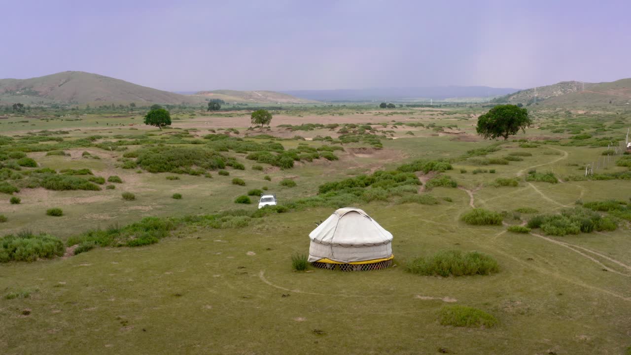 Small yurt in the middle of the vast Mongolian grassland steppe