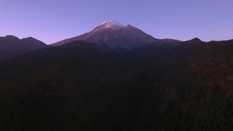 aerial traveling video of the pico de orizaba volcano and a big ravine in the middle