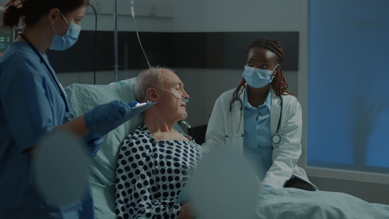 Multi ethnic medical staff talking about treating patient