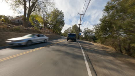 Cinematic-FPV-shot-of-a-new-electric-police-SUV-racing-along-the-country-roads