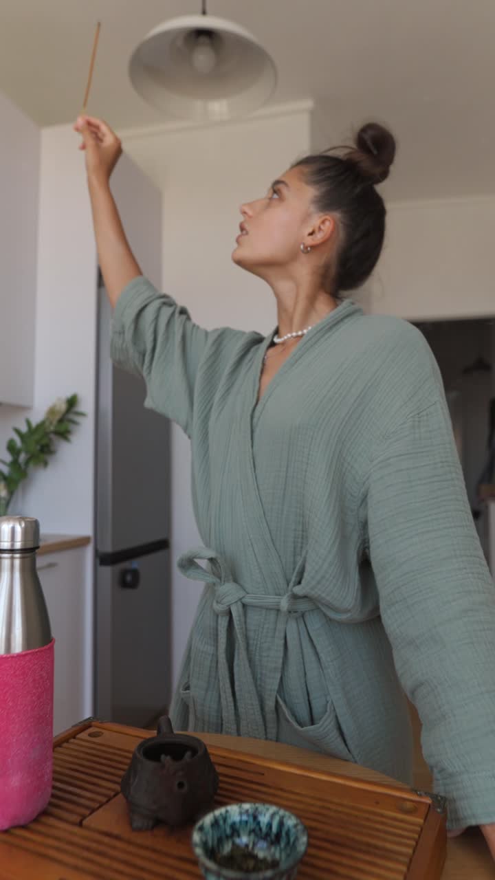 Woman burning incense during tea ceremony