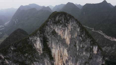 Steep-karst-mountain-rock-face,-Getu-Valley-rock-climbing-region,-China,-aerial