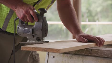 closeup of construction worker using jigsaw