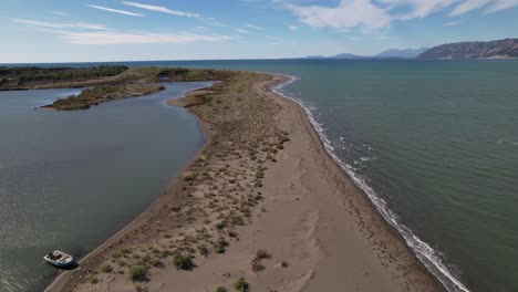 banco de arena separa la laguna con aguas poco profundas de agua de mar salada en la costa de albania, lugar de pesca ideal