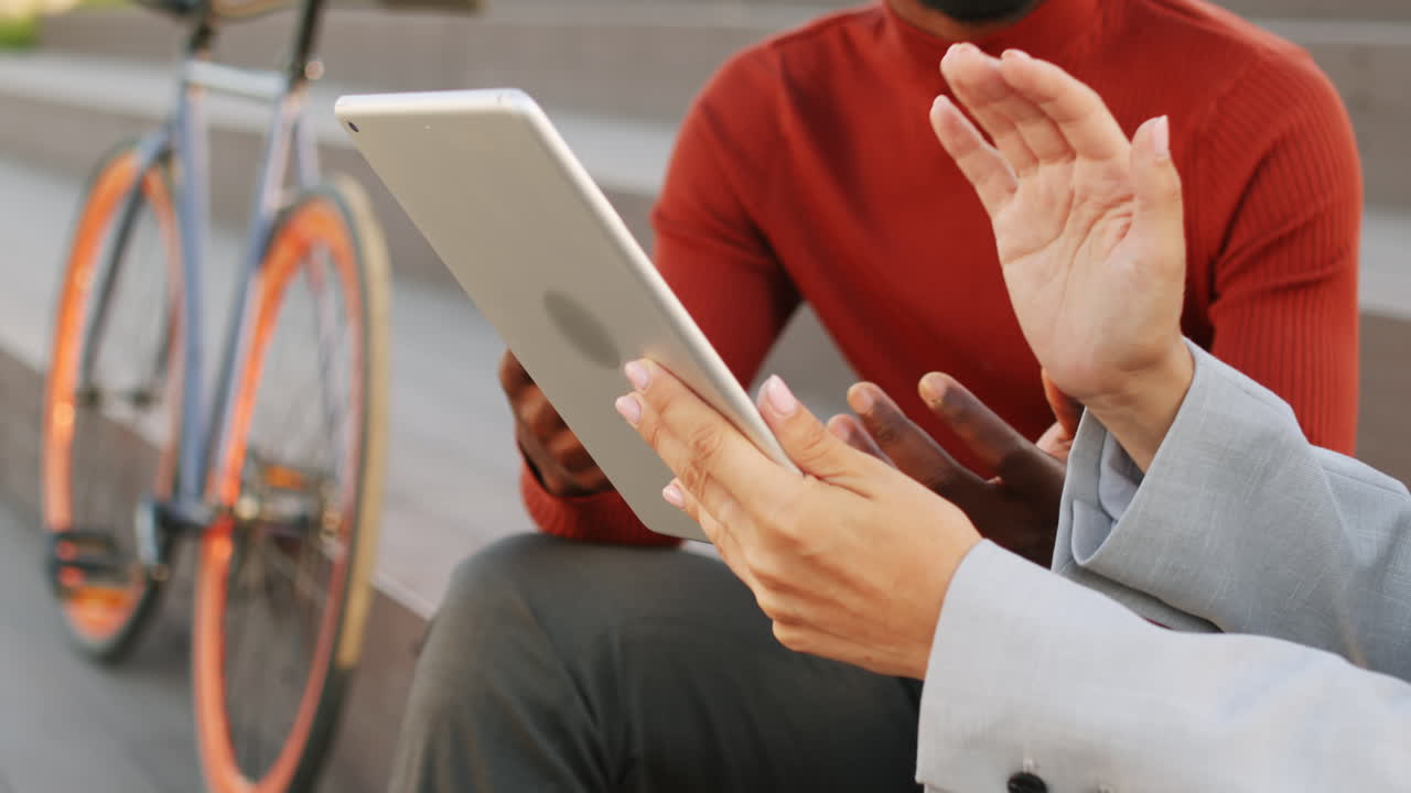 Hands of Business Partners Gesticulating and Holding Digital Tablet