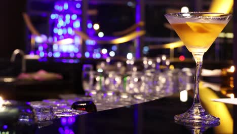 pouring a cocktail in a vibrant, luxurious bar setting