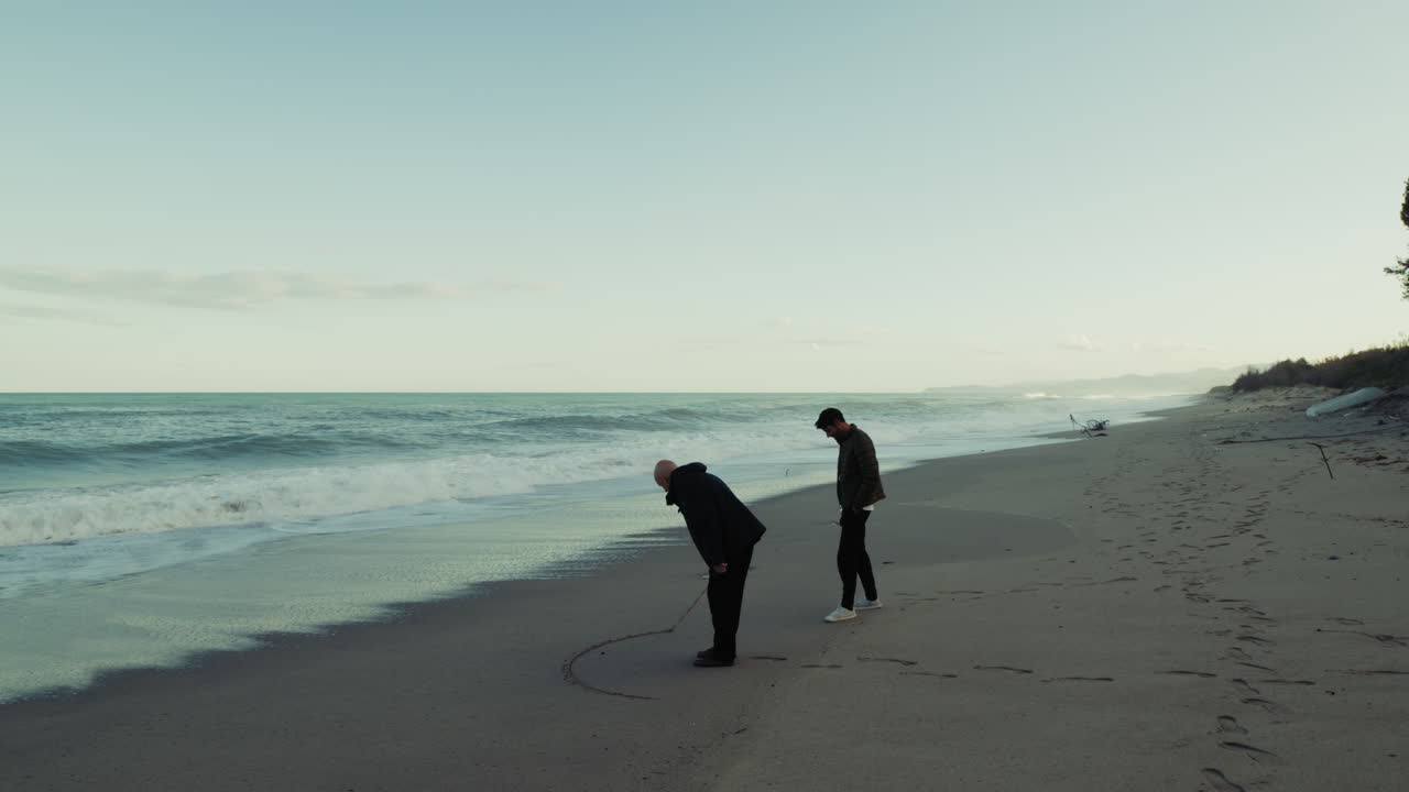 Father's Day With Adult Son On The Beach Watching The Stormy Ocean