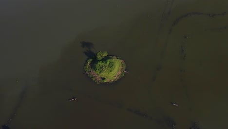 flying-away-from-a-tiny-island-with-small-fisher-boats-driving-by-in-Bangladesh