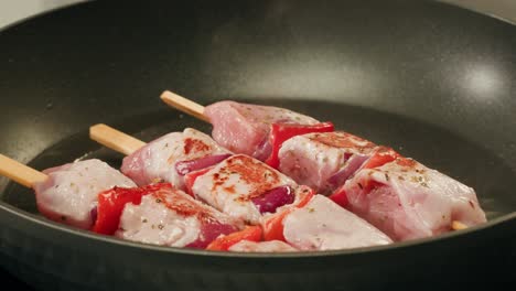 cooking pork skewers with peppers