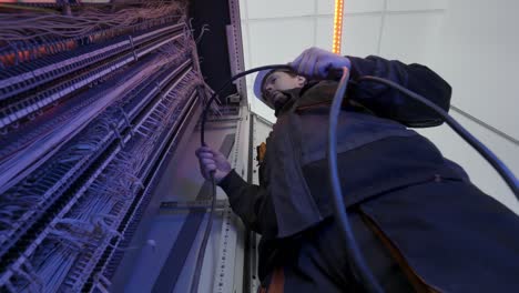 electrician working on electrical panel