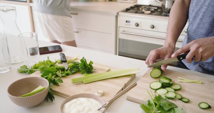 Two People Preparing Fresh Vegetables in a Kitchen