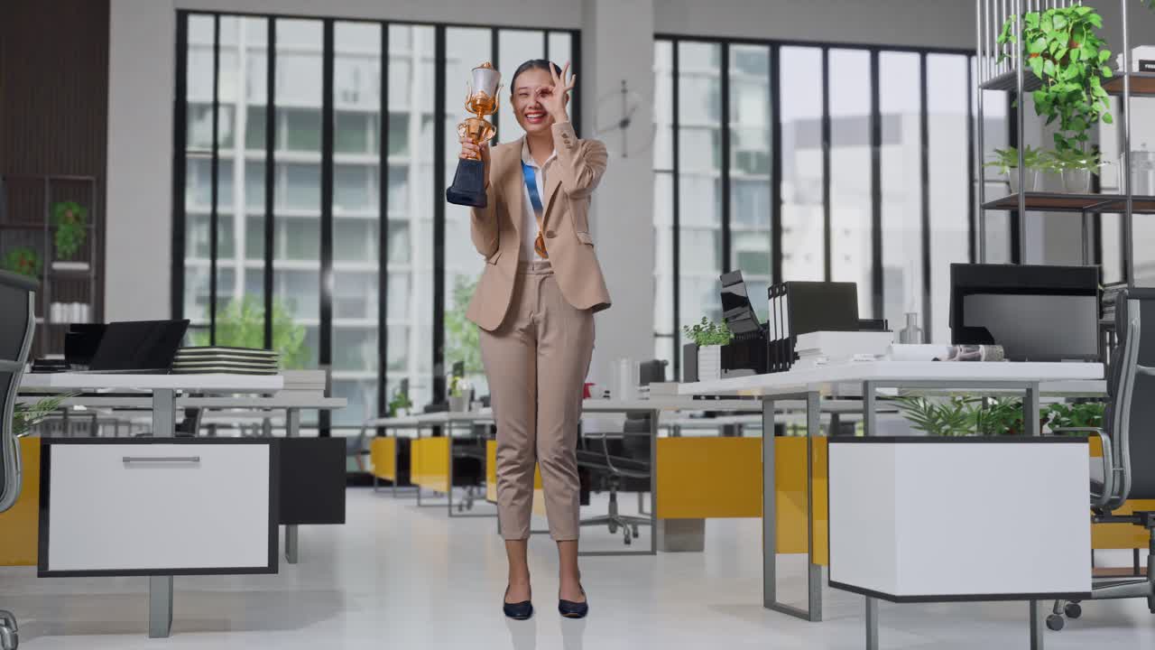 Woman Celebrating Achievement in Modern Office