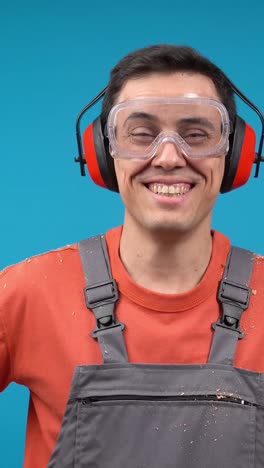 happy worker in safety gear giving thumbs up