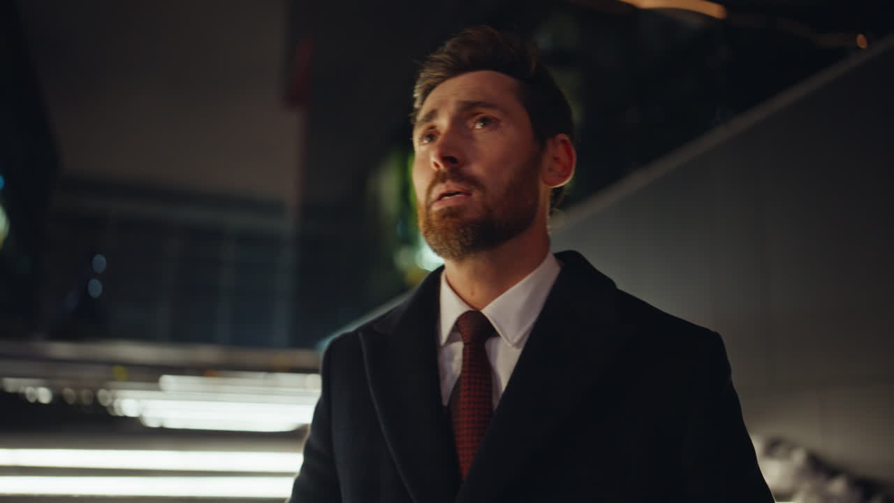 Worried ceo speaking mobile phone at night city view portrait. Sad man talking