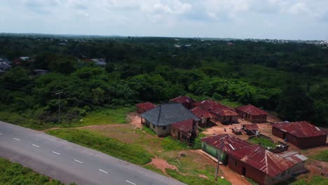 drone tilts down as cloud shadow passes rusted rooftops of old ibadan housing compound
