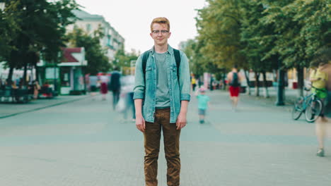 young man standing on city street