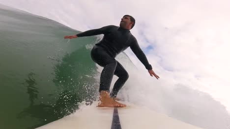 Surfer-Riding-green-Wave-getting-some-water-on-air-at-slow-motion,-Sintra-2022