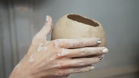 young woman makes a jug of clay. female hands mold pottery