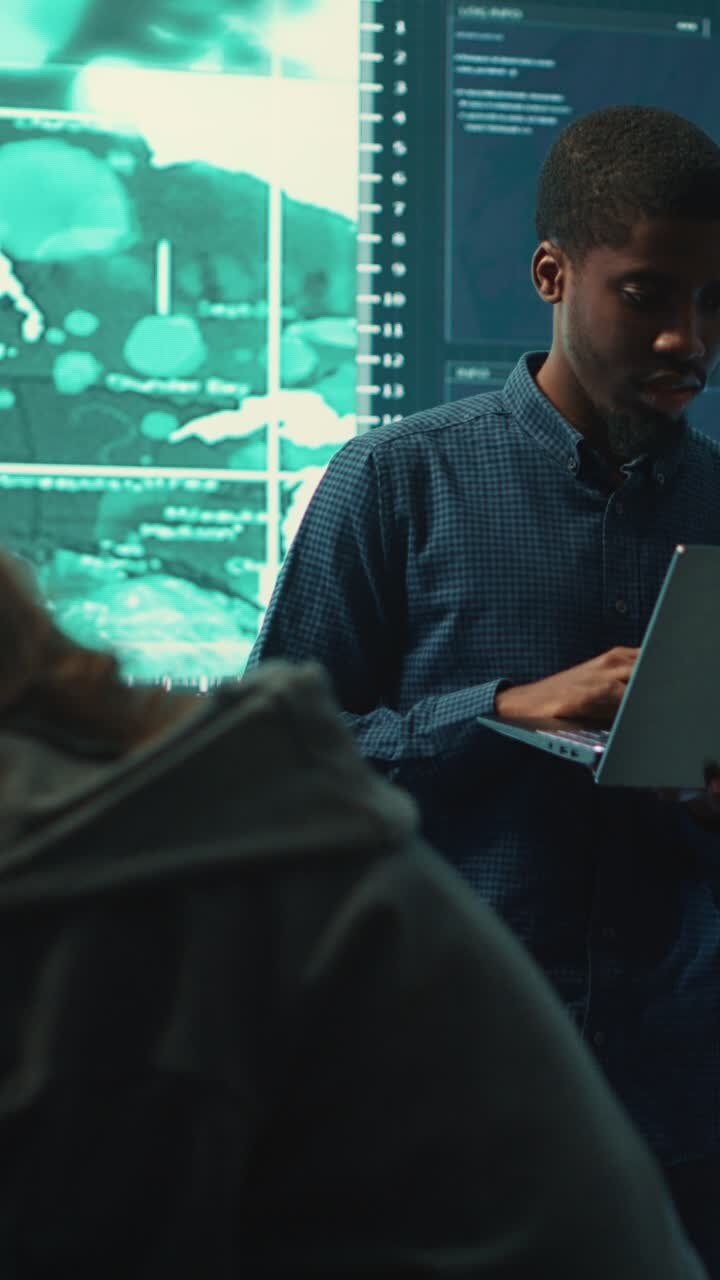 African American Man Working on Laptop in High-Tech Office