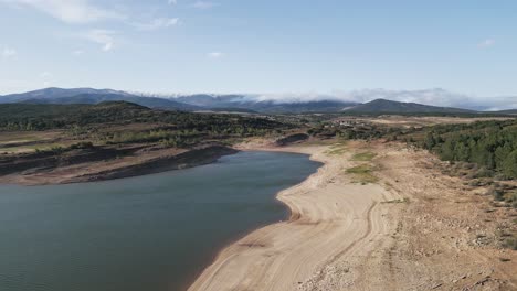 aerial view of a water reservoir at sunset with low water level in summer