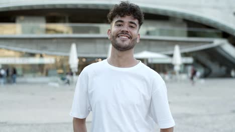 Cute-curly-man-posing-on-street