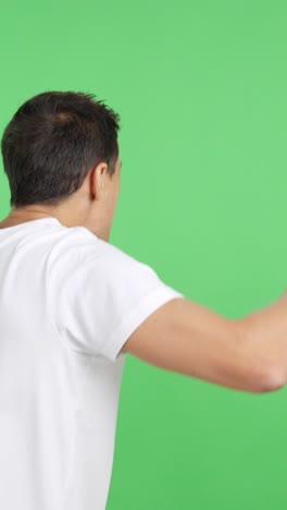 rear view of a man waving a greek pennant