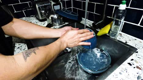 person washing dishes in a paris kitchen