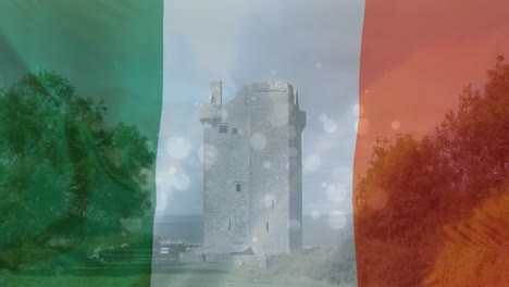 medieval tower in the land with an irish flag on the foreground