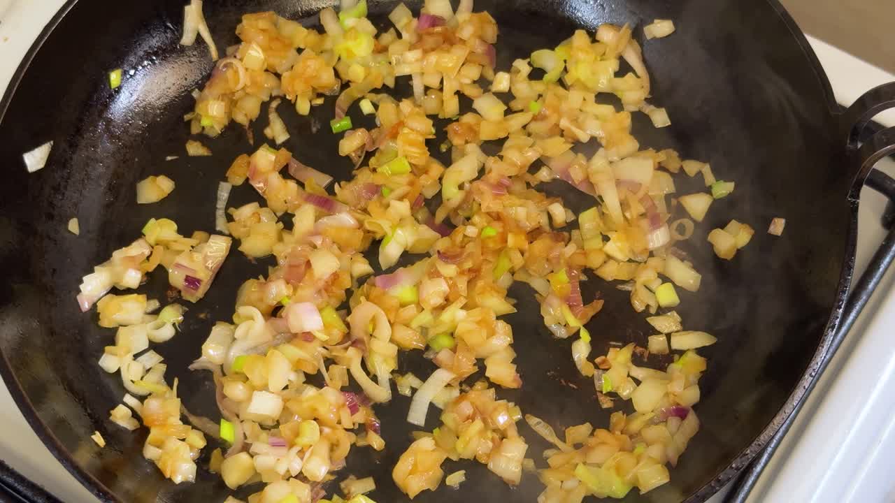 Sautéing White Onion In A Pan. Close-up Shot