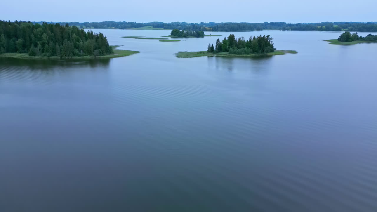 Aerial Drone Shot with Slight Tilt Down View of Natural Beauty Over a Scenic Lake with Islands in Latvia