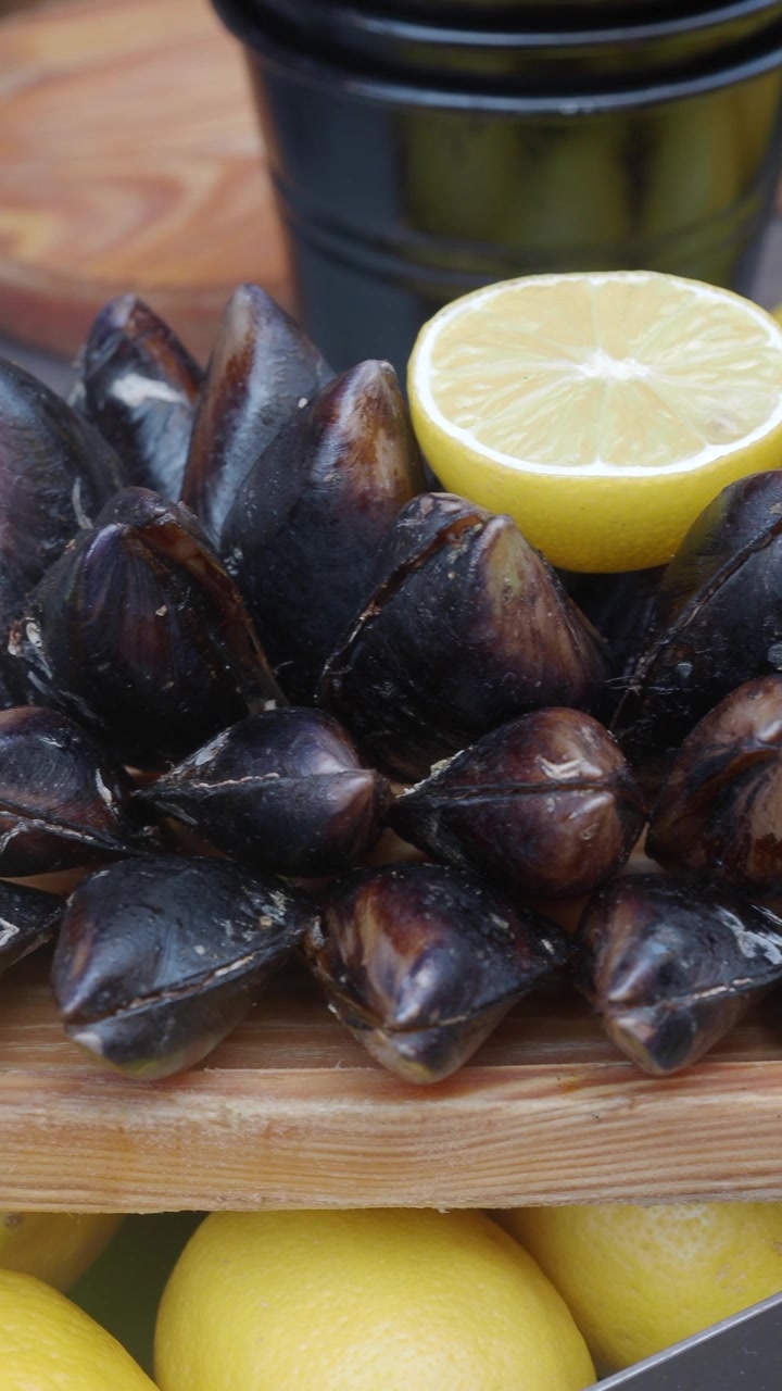 Close-up of Prepared Mussels with Fresh Lemon Halves