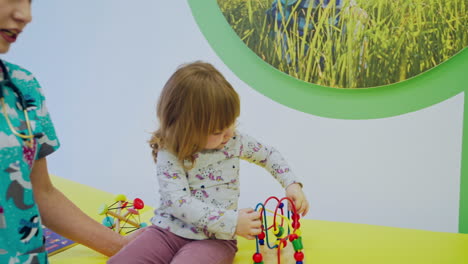 doctor examining little girl. cute woman pediatrician examining of girl kid