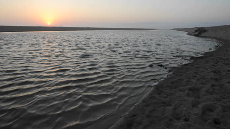 Time-lapse-of-sun-setting-over-a-coastal-estuary-at-McGrath-Beach-State-Park-in-Ventura-California